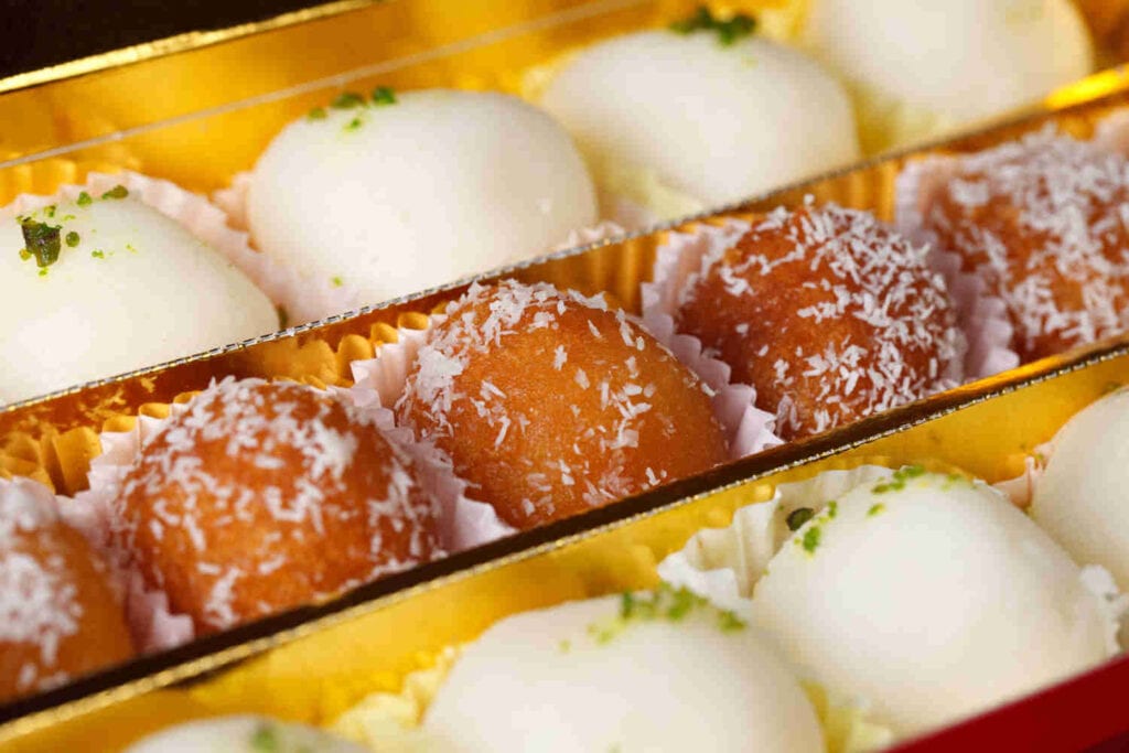 Assorted Indian milk-based sweets in golden box